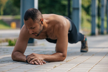 Young well-built african american man standing in plank