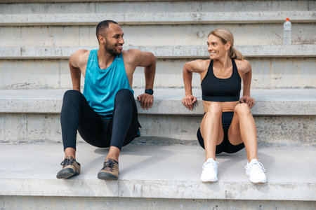 Sporty woman and man doing reverse push ups outdoors.の写真素材