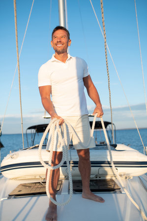 Contented and determined mature man on a yachtの写真素材