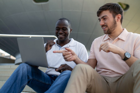Two colleagues working together remotely and looking involved