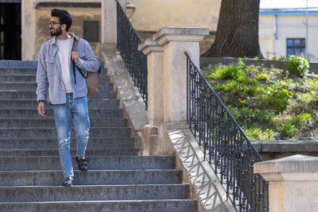 Young tall hindu man standing on the steps of an old buildingの写真素材