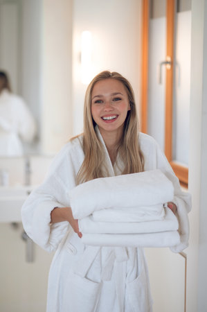 Young woman with towels smiling and looking contentedの写真素材