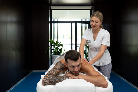 Man having back massage session and looking contentedの写真素材