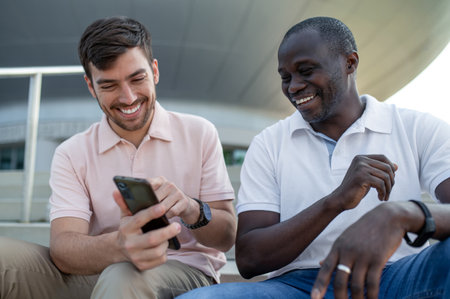 Two friends watching something on the phone and smiling