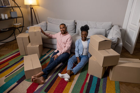 Couple moving to new house together holding boxes parcel enjoying relocation