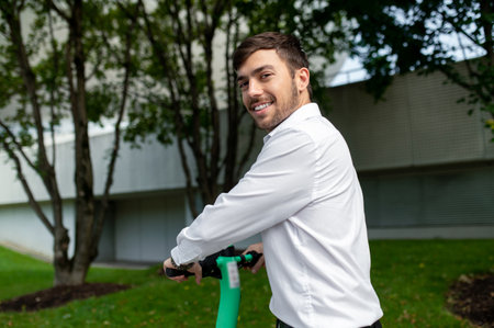 Young man on electric scooter in the city street