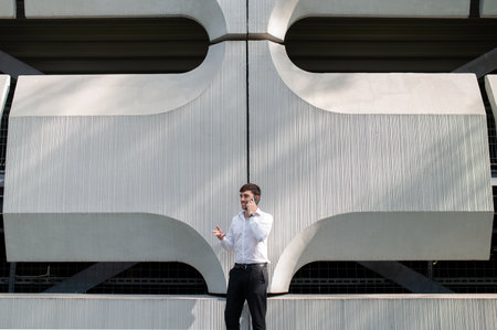 Young man in the city center on a big building background