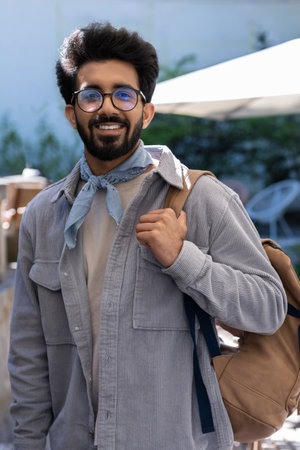 Young hindu man with a backpack roaming about the city