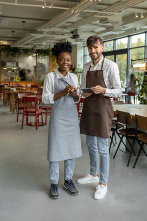Pizzeria worker standing together and discussing something