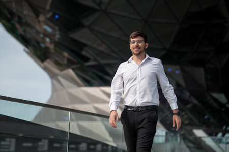Good-looking young man in elegant outfit on urban backgroundの写真素材
