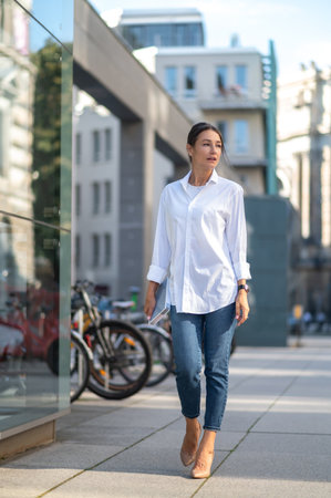 Cute smiling woman in the city streetの写真素材