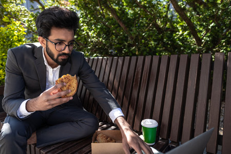 Hindu young businessman working and having lunch