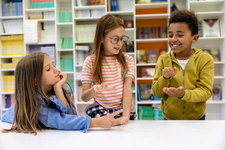 Children sitting in school library.の写真素材