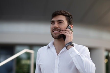 Smiling young businessman talking on the phone