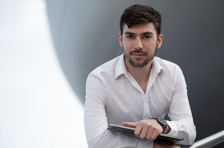 Young manager in white shirt with a laptop
