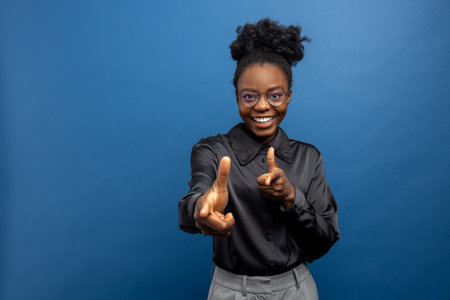 Dark-skinned young woman looking excited and joyfulの写真素材