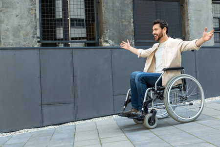 Young man on a wheelchair feeling free and excitedの写真素材