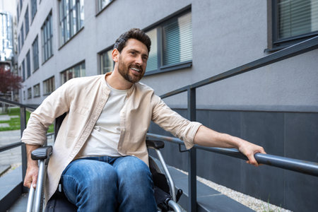 Disabled man on a wheelchair looking positive and smilingの写真素材