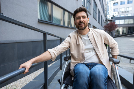 Dark-haired bearded young man on a wheelchairの写真素材