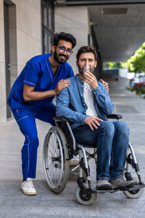 Young man sitting in wheelchair and wearing an oxygen mask