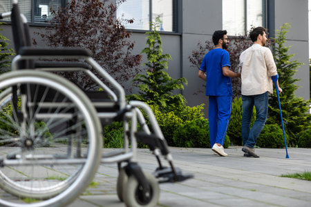 Male nurse having a walk with a patient in a rehabilitation center