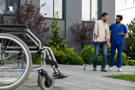 Male nurse having a walk with a patient in a rehabilitation center
