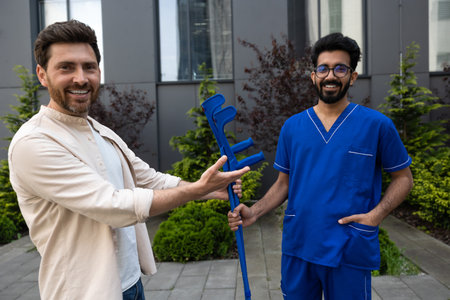 Man with crutches talking to a doctor and feeling excited
