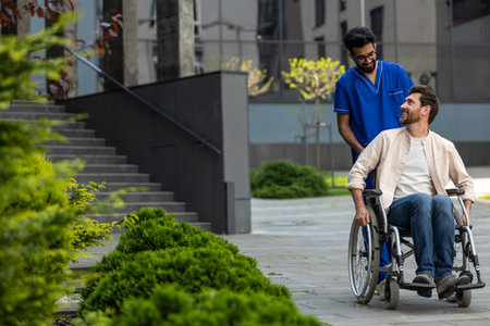 Male nurse rolling a wheelchair with patient and both feeling good