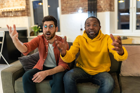 Two men watching football and looking excited
