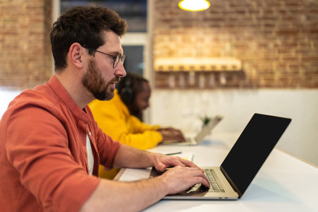 Two men looking involved while working in a home office