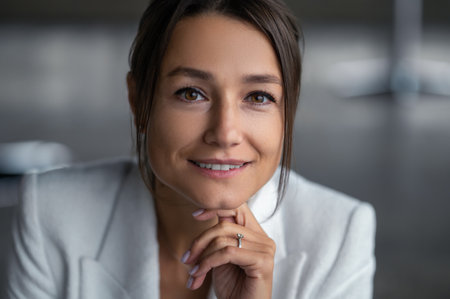 Portrait of a cute caucasian woman in white jacketの写真素材