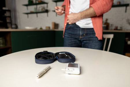 Equipment for diabetic people with man making medical insulin syringe injection into abdomenの写真素材