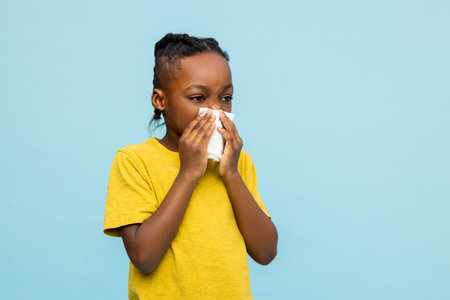 Unhealthy African American little boy suffering flu symptomsの写真素材