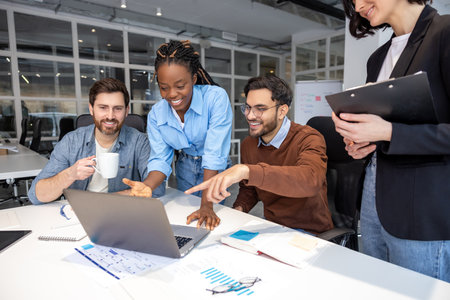 Group of diverse businesspeople using laptop while working together