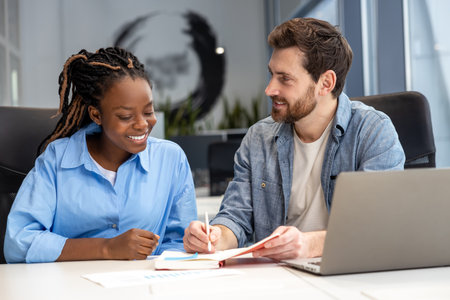 Multicultural colleagues using laptop for creating new business project