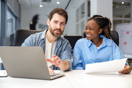 Multicultural colleagues using laptop for creating new business project