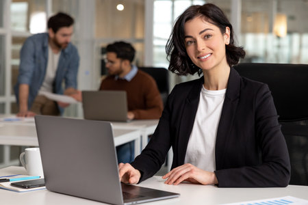 Office employee working on computer in modern coworking environment