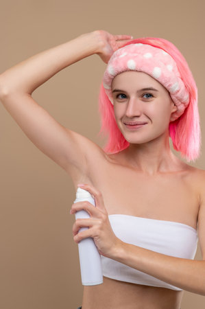 Woman using antiperspirant after taking shower