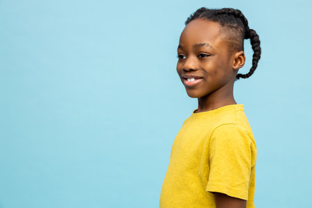 Waist up of a cute african american boy in yellow tshirtの写真素材