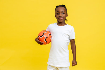 Mixed-race little boy having football workout with ball