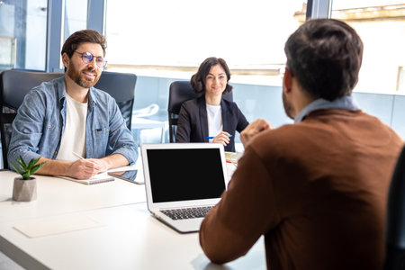 Colleagues working in collaborative office environment