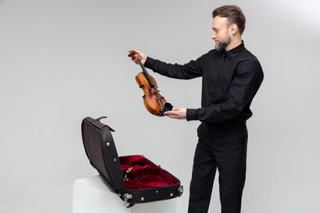 Violist man with instrument in caseの写真素材