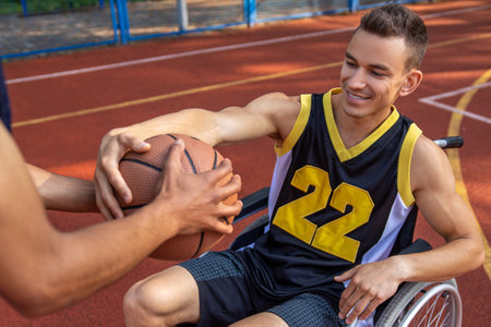 Basketball player with disability training on basketball courtの写真素材