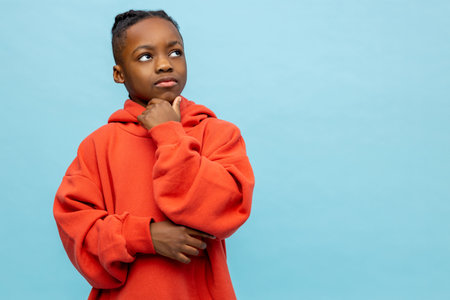 Cute african american boy in orange hoodieの写真素材