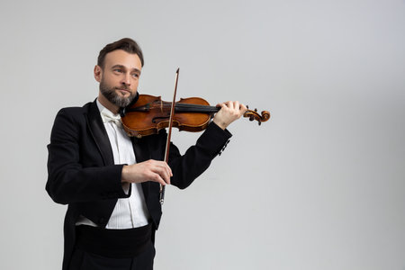 Bearded man passionate violin player at classical music performanceの写真素材