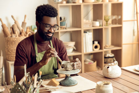 Professional working in a pottery studio on creation of a new product