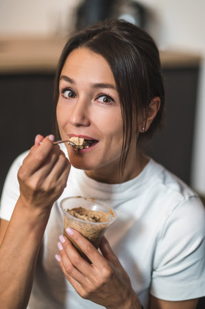 Young woman spending time at home and enjoying a dessertの写真素材