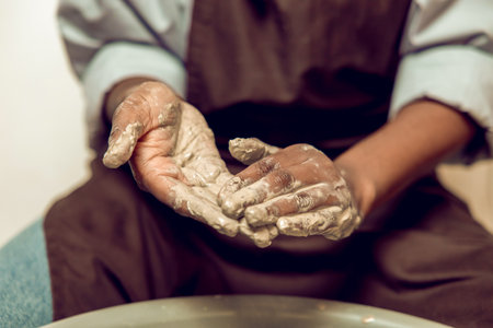 Close up of a person working with wet clayの写真素材