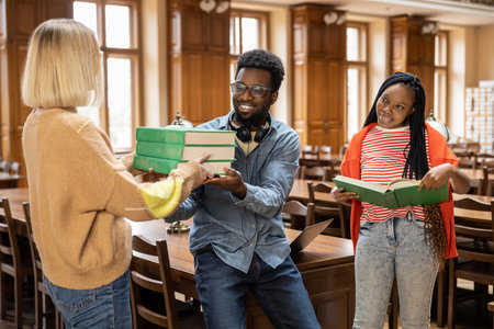 Group of young people in the library looking busy and involved