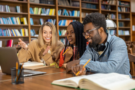 Students studying in the library and looking involved